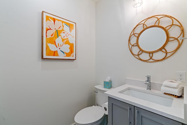 bathroom featuring toilet and vanity