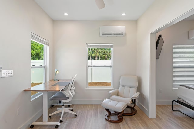 office area featuring recessed lighting, a wall mounted air conditioner, light wood-style flooring, and baseboards