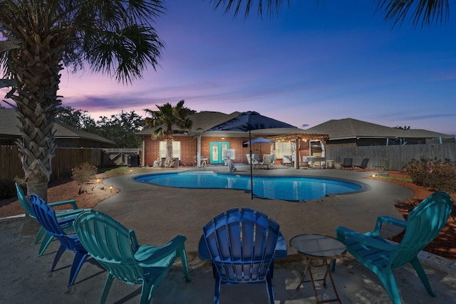 view of pool with a storage structure, a patio area, a fenced backyard, and an outdoor structure