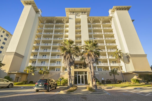 view of property featuring uncovered parking