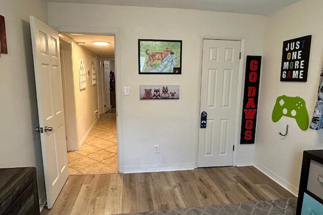 interior space featuring baseboards and light wood-type flooring