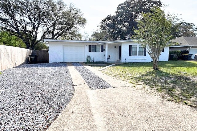 ranch-style house with driveway, a front yard, fence, and a garage
