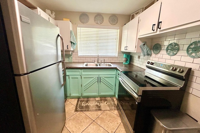 45 NE Arizona Dr, Fort Walton Beach, FL 32548 - kitchen featuring appliances with stainless steel finishes, tasteful backsplash, green cabinetry, light tile patterned floors, and white cabinetry