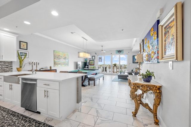 kitchen with a sink, marble finish floor, light countertops, dishwasher, and tasteful backsplash