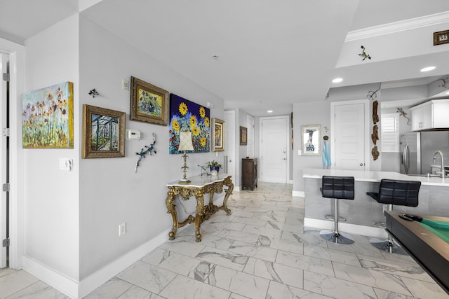 interior space featuring marble finish floor, baseboards, and recessed lighting