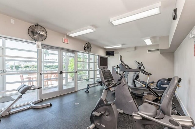 gym with a wealth of natural light, visible vents, and baseboards