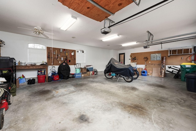 garage with a workshop area and a garage door opener