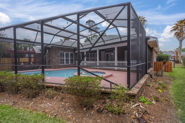 view of pool featuring a fenced in pool, an in ground hot tub, a lanai, fence, and a patio area