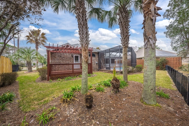 view of yard featuring glass enclosure, a fenced backyard, a deck, and a fenced in pool