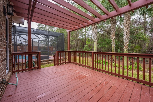 wooden terrace featuring glass enclosure and a pergola