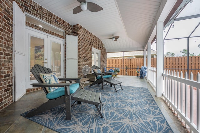 view of patio / terrace with french doors, glass enclosure, ceiling fan, and fence