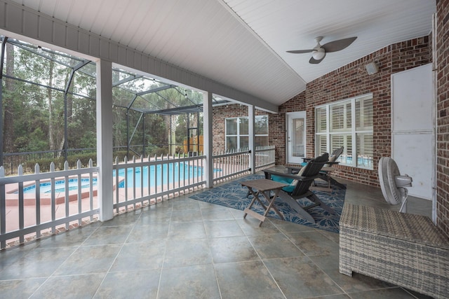 unfurnished sunroom with lofted ceiling and ceiling fan