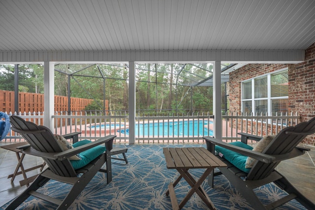 view of patio featuring a fenced in pool, glass enclosure, and fence