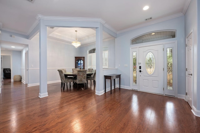 foyer featuring dark wood-style floors, visible vents, and crown molding