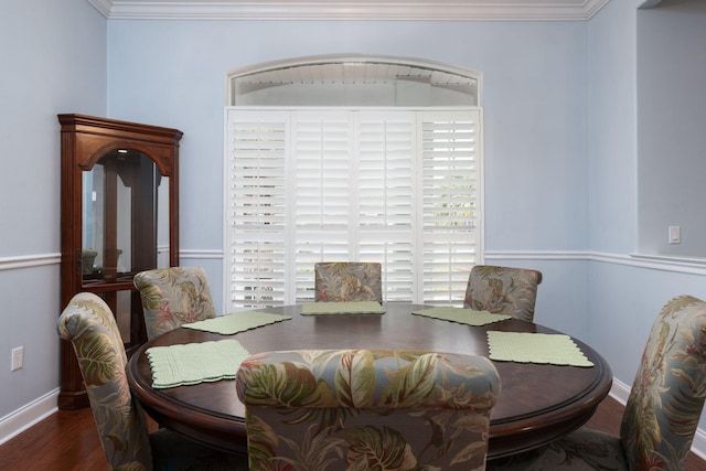 dining area with baseboards, dark wood-style flooring, and crown molding