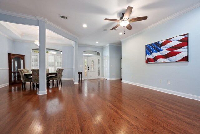 living room featuring dark wood-style floors, baseboards, visible vents, and crown molding