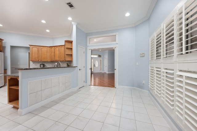 kitchen with brown cabinets, a peninsula, visible vents, and open shelves