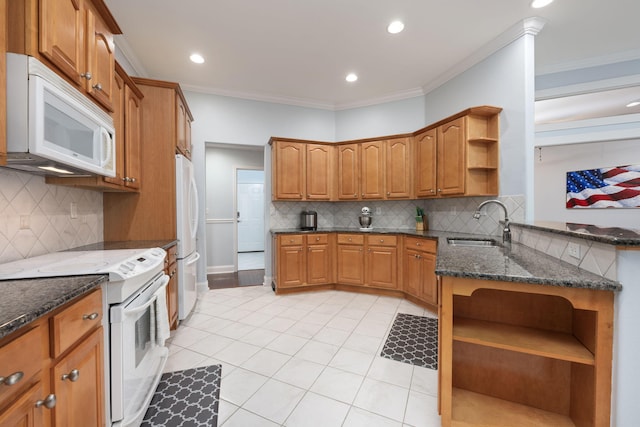 kitchen featuring open shelves, brown cabinetry, a sink, dark stone countertops, and white appliances