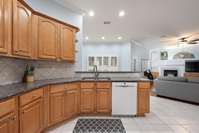 kitchen featuring visible vents, open floor plan, white dishwasher, a sink, and dark stone counters