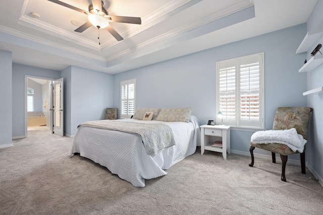 bedroom featuring a tray ceiling, multiple windows, and light colored carpet