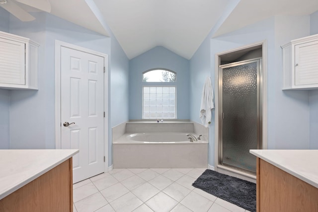 full bathroom featuring a stall shower, a garden tub, vaulted ceiling, and vanity