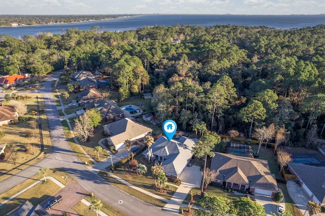 bird's eye view with a water view and a forest view