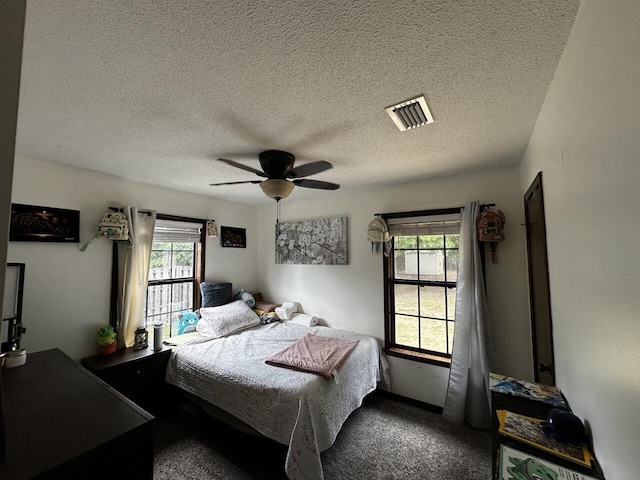 223 W Pinoak Ct, Crestview, FL 32539 - bedroom featuring a textured ceiling, a ceiling fan, and carpet