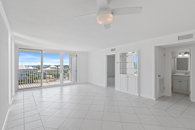 unfurnished bedroom featuring visible vents, baseboards, access to outside, a wall of windows, and light tile patterned flooring