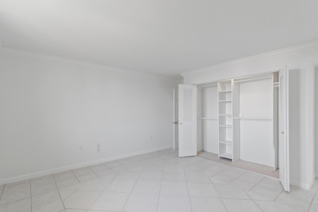 unfurnished bedroom with baseboards, a closet, and crown molding