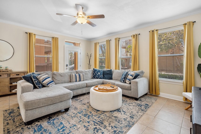 living area featuring baseboards, ornamental molding, a ceiling fan, and light tile patterned flooring