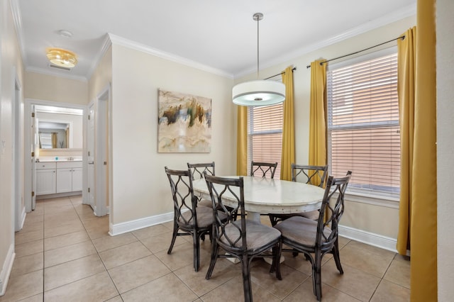 dining area featuring baseboards, light tile patterned flooring, and crown molding