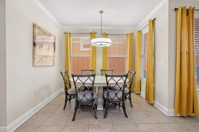 dining area featuring light tile patterned floors, ornamental molding, and baseboards