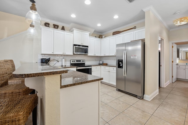 kitchen featuring stainless steel appliances, light tile patterned flooring, a peninsula, and white cabinetry