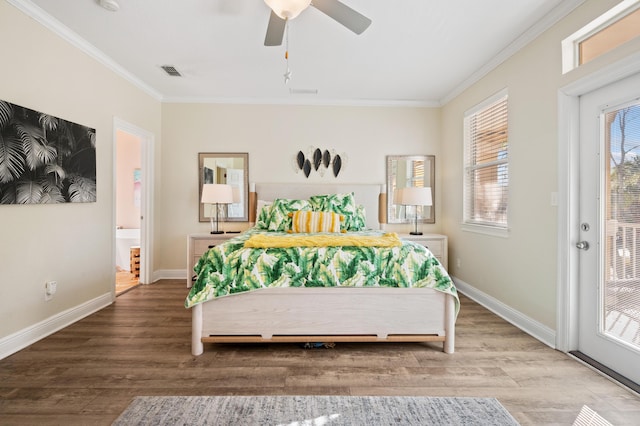 bedroom with crown molding, visible vents, ceiling fan, wood finished floors, and baseboards