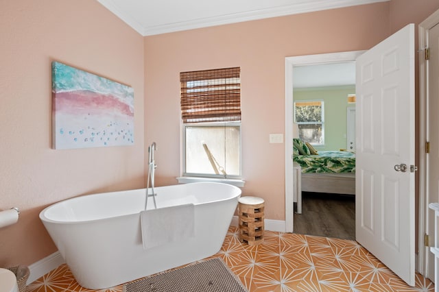 bathroom with a soaking tub, crown molding, baseboards, and ensuite bathroom