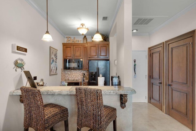 kitchen with visible vents, brown cabinets, hanging light fixtures, crown molding, and black appliances