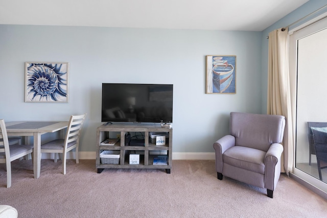 interior space with baseboards and light colored carpet