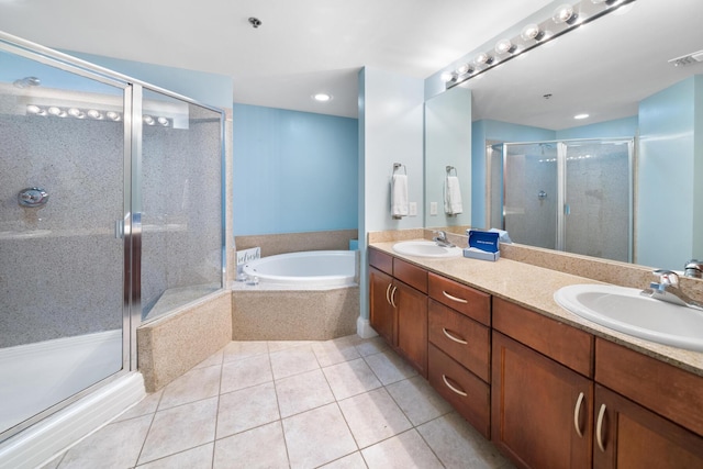 bathroom with tile patterned flooring, a sink, a shower stall, and a bath