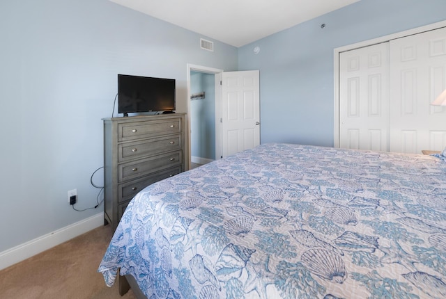 bedroom with light carpet, baseboards, visible vents, and a closet