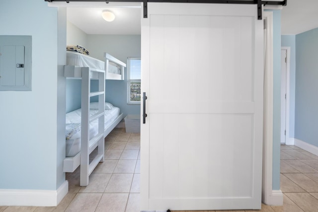 bathroom with electric panel, baseboards, and tile patterned floors