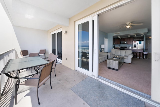 balcony featuring a patio, visible vents, a ceiling fan, and outdoor dining space