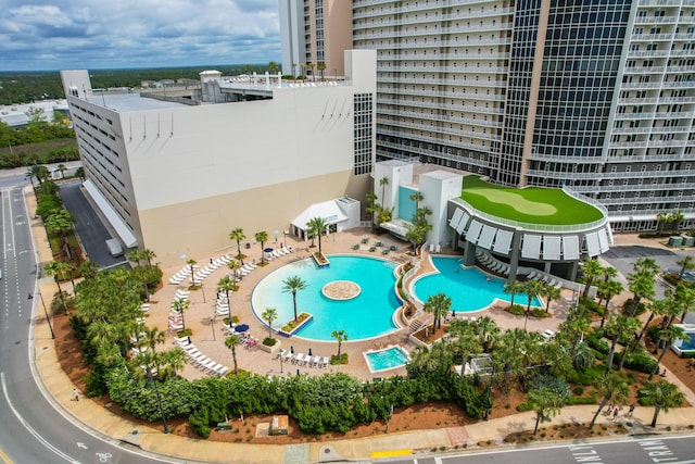 view of swimming pool featuring a patio area and a city view