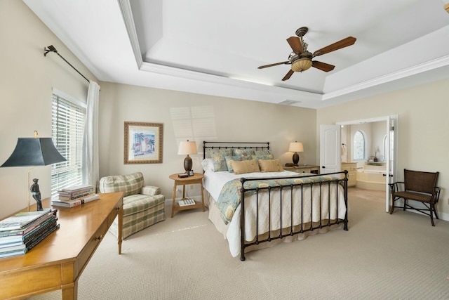 bedroom featuring a raised ceiling, light colored carpet, visible vents, ceiling fan, and baseboards