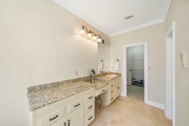 full bathroom featuring vanity, visible vents, baseboards, a spacious closet, and ornamental molding