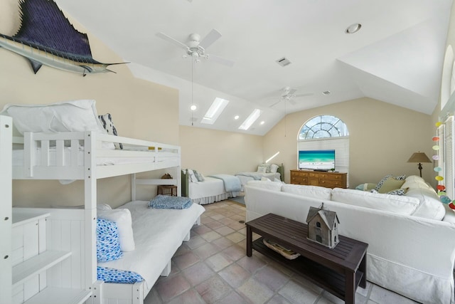 bedroom featuring vaulted ceiling with skylight, visible vents, and a ceiling fan