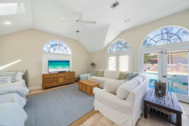 living area featuring a healthy amount of sunlight, visible vents, and vaulted ceiling