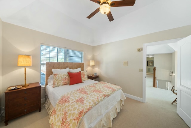 bedroom with light carpet, baseboards, vaulted ceiling, and a ceiling fan