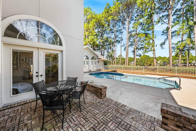 view of swimming pool featuring a fenced in pool, fence, a patio, and french doors