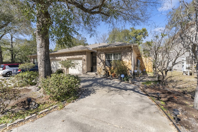 view of front of house featuring concrete driveway, brick siding, and an attached garage