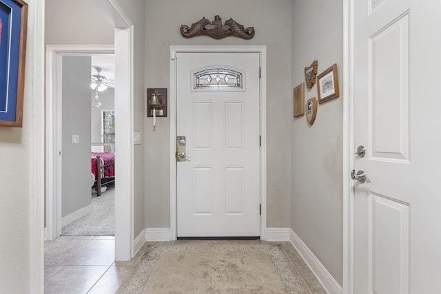 foyer entrance featuring baseboards and light tile patterned floors